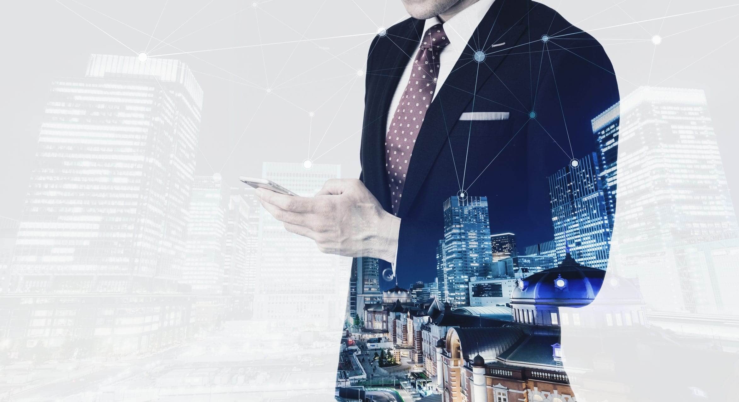 Businessman using smartphone with cityscape overlay.
